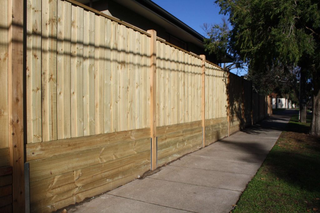 Treated Pine paling fence with Sleepers fitted underneath to retain soil.